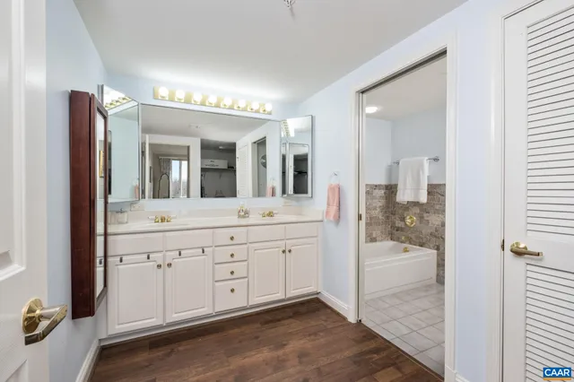 a spacious bathroom with a shower sink and mirror