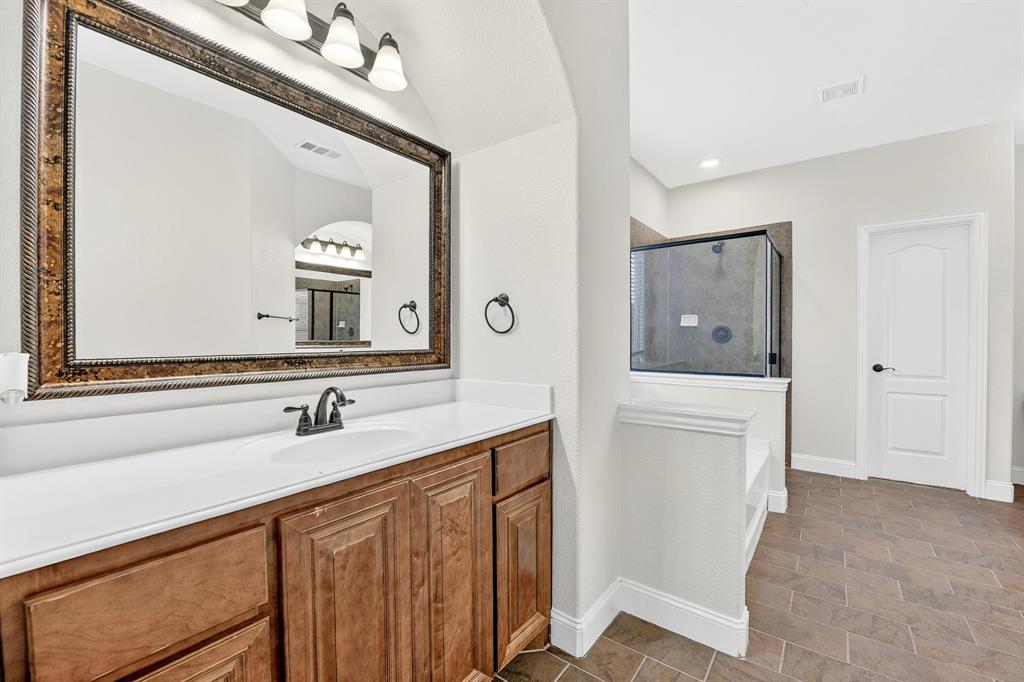 4308 Spruce Road Melissa, TX 75454 - Photo 25 of 39 a bathroom with a sink vanity and mirror