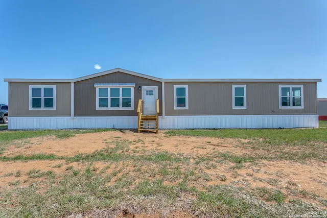 a house view with a backyard space