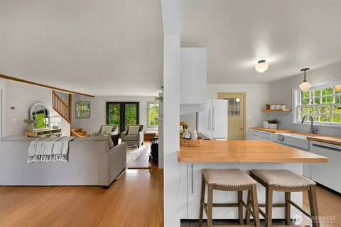 a living room with dining table and wooden floor
