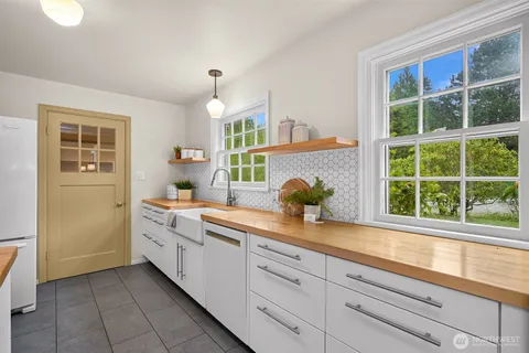 a kitchen with sink and cabinets