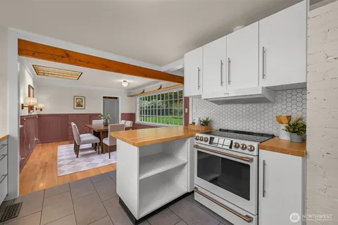 a kitchen with granite countertop a stove and a sink