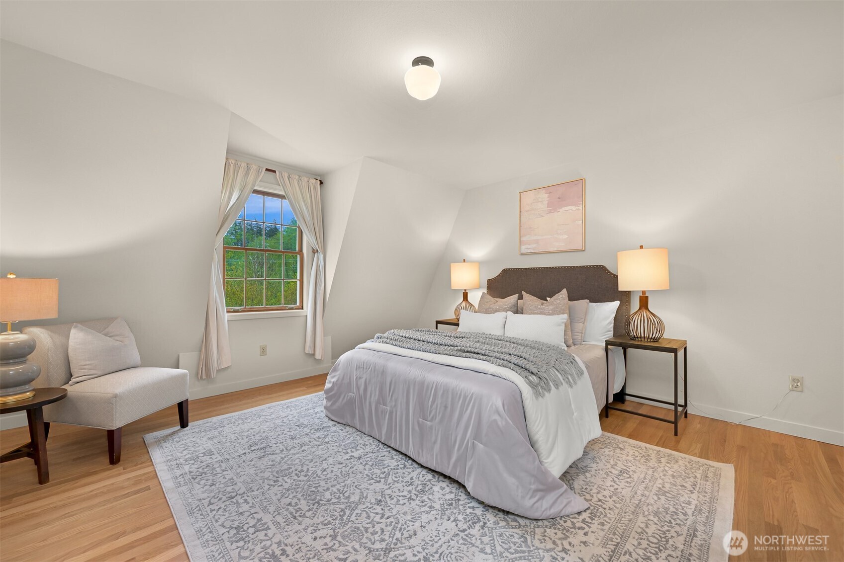 2814 40th Street Bellingham, WA 98229 - Photo 20 of 39 a spacious bedroom with a bed a couch and a window