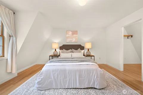 a bed sitting in a bedroom next to a window