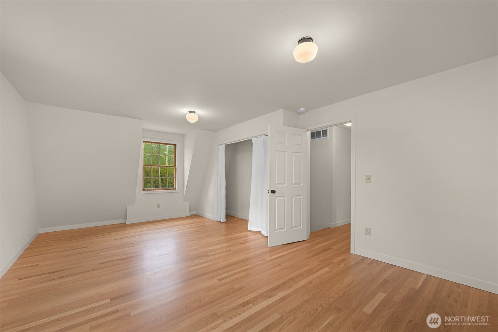 2814 40th Street Bellingham, WA 98229 - Photo 27 of 39 a view of an empty room with wooden floor and a window