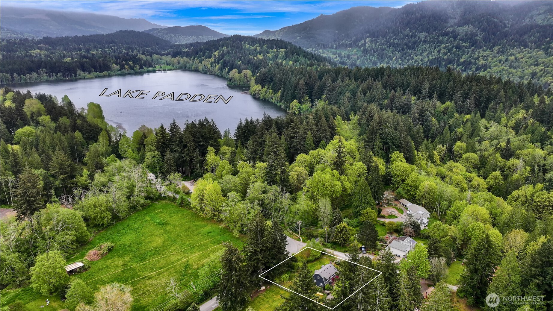 2814 40th Street Bellingham, WA 98229 - Photo 3 of 39 a view of a lush green field with mountains in the background