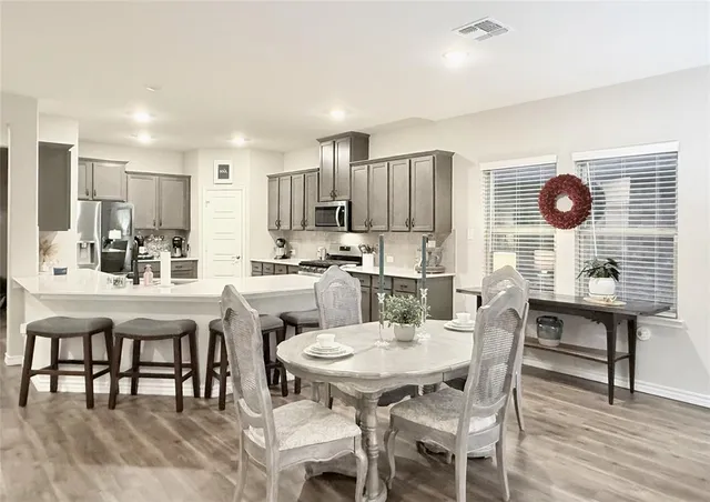 a view of a dining room with furniture and wooden floor