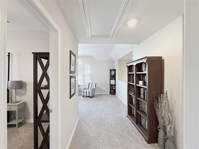 a view of a hallway with seating area