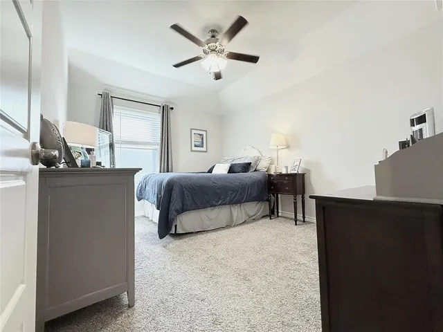 a bedroom with bed and window