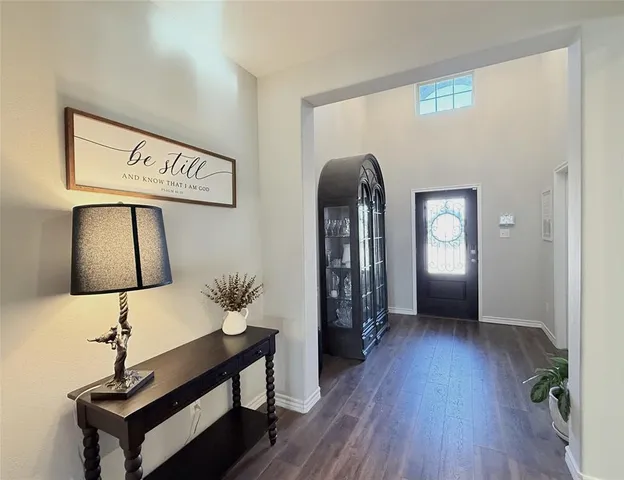 a view of hallway with furniture and wooden floor
