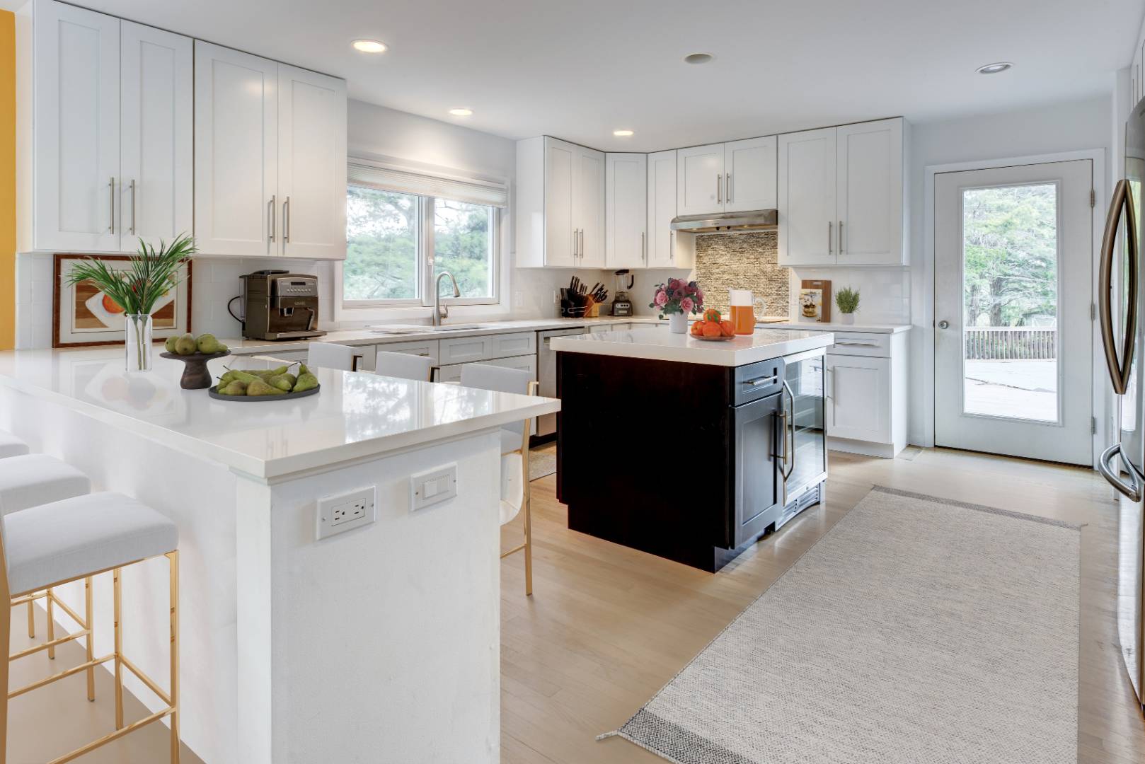 32 Reynolds Drive Westhampton Beach, NY 11978 - Photo 6 of 17 a kitchen with kitchen island granite countertop a stove refrigerator and microwave