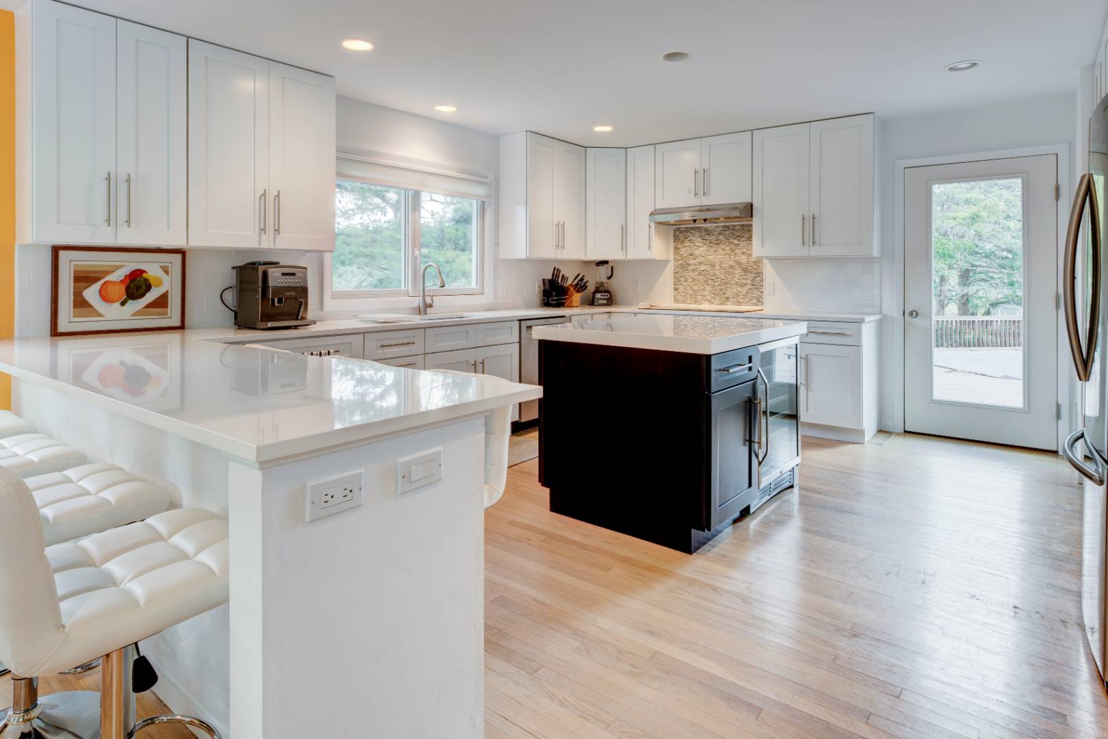 32 Reynolds Drive Westhampton Beach, NY 11978 - Photo 7 of 17 a kitchen with stainless steel appliances granite countertop a stove top oven a refrigerator a sink and dishwasher with wooden floor