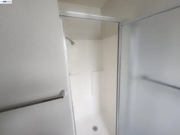 a bathroom with a glass shower door