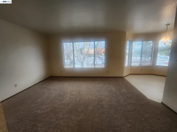 an empty room with a empty space and windows