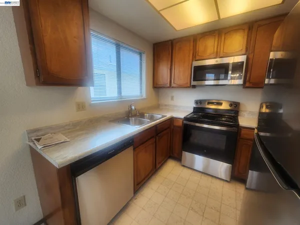 a kitchen with a sink stove and microwave