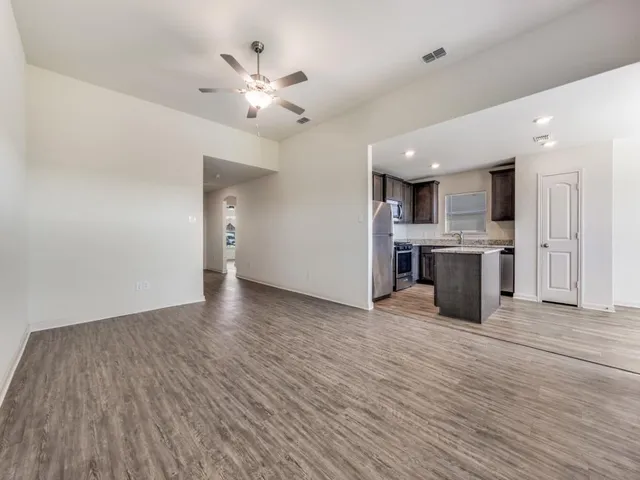 a view of a kitchen with a sink and a window