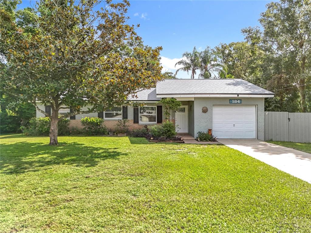 184 Groveland Road Mount Dora, FL 32757 - Photo 1 of 1 a front view of a house with a yard and garage