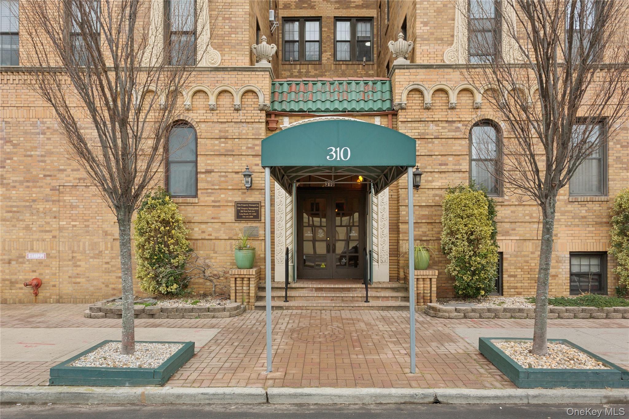 310 Riverside Boulevard, Unit 1H Long Beach, NY 11561 - Photo 1 of 1 Property entrance with brick siding and french doors