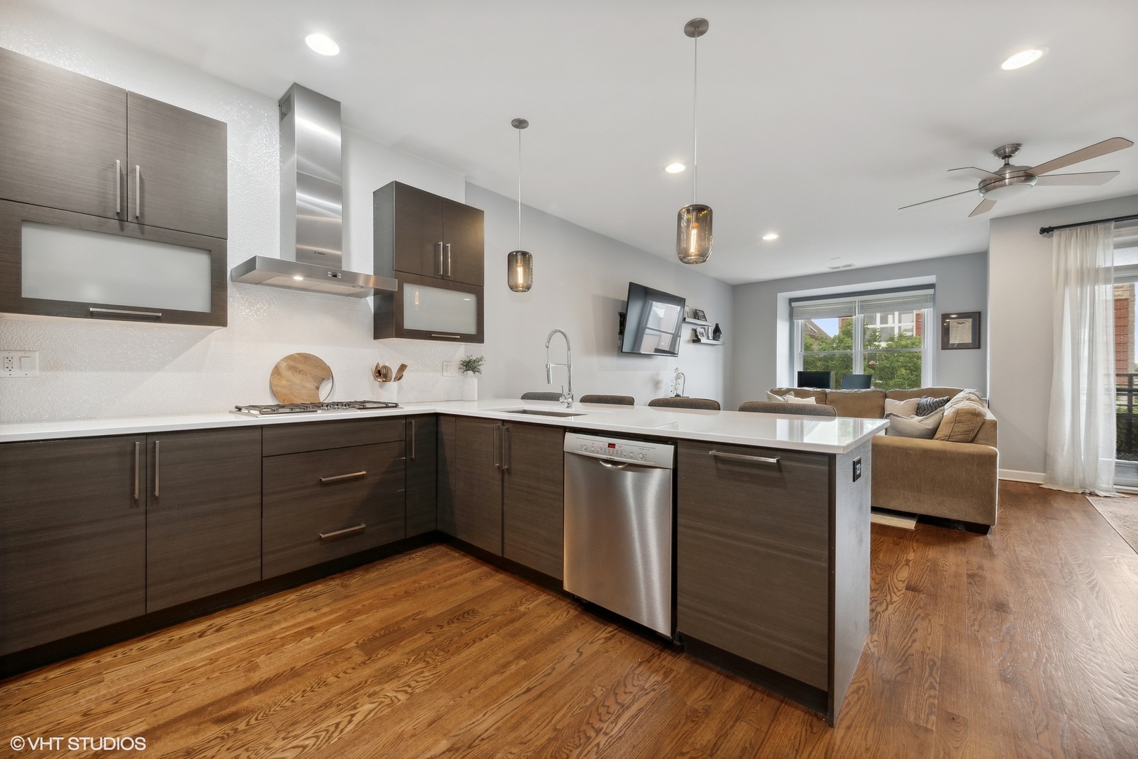 2128 West Rice Street, Unit 4 Chicago, IL 60622 - Photo 8 of 20 a kitchen with stainless steel appliances granite countertop a sink dishwasher a stove and a refrigerator with wooden floor
