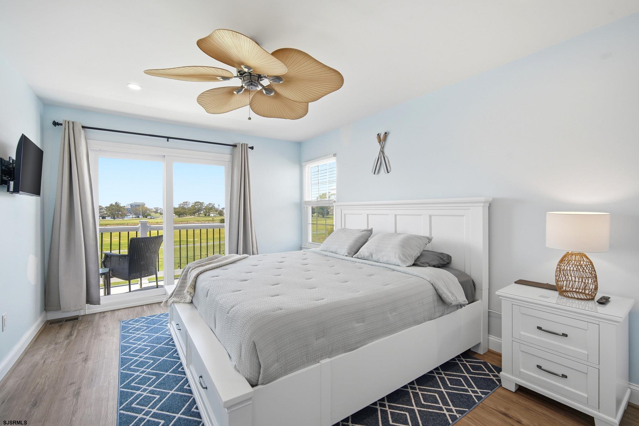 214 Hagen Road Brigantine, NJ 08203 - Photo 24 of 34 a bedroom with a large bed and a chandelier