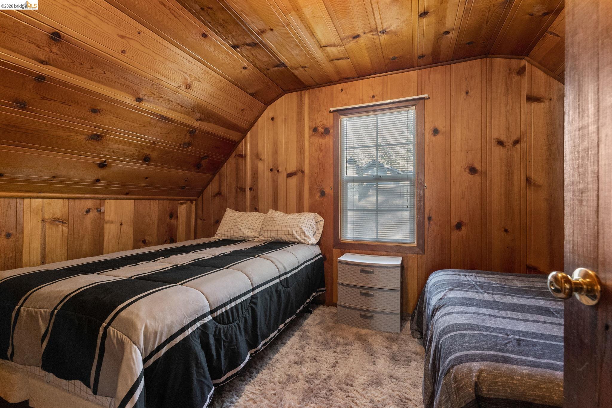 26175 Janice Way Long Barn, CA 95335 - Photo 17 of 23 Carpeted bedroom featuring a vaulted wooden ceiling and wooden walls