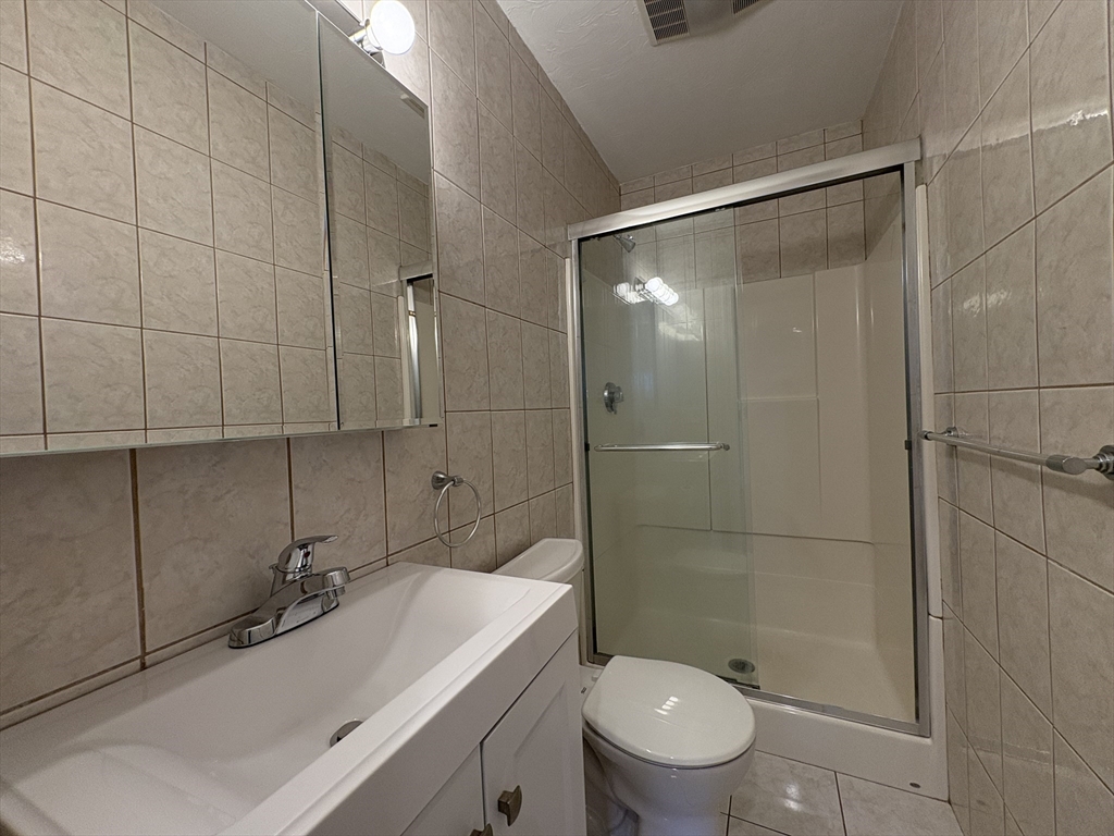 73 Thatcher Street, Unit 301 Brookline, MA 02446 - Photo 11 of 15 a bathroom with a sink toilet and shower