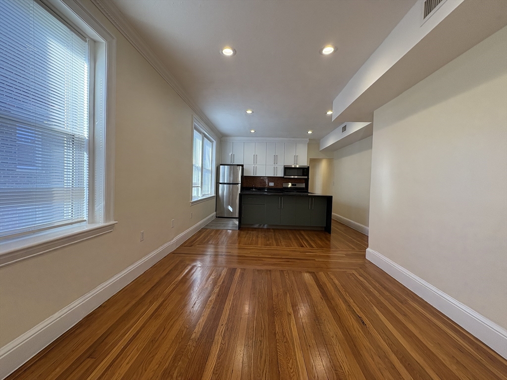 73 Thatcher Street, Unit 301 Brookline, MA 02446 - Photo 5 of 15 a view of kitchen with cabinets wooden floor and stainless steel appliances