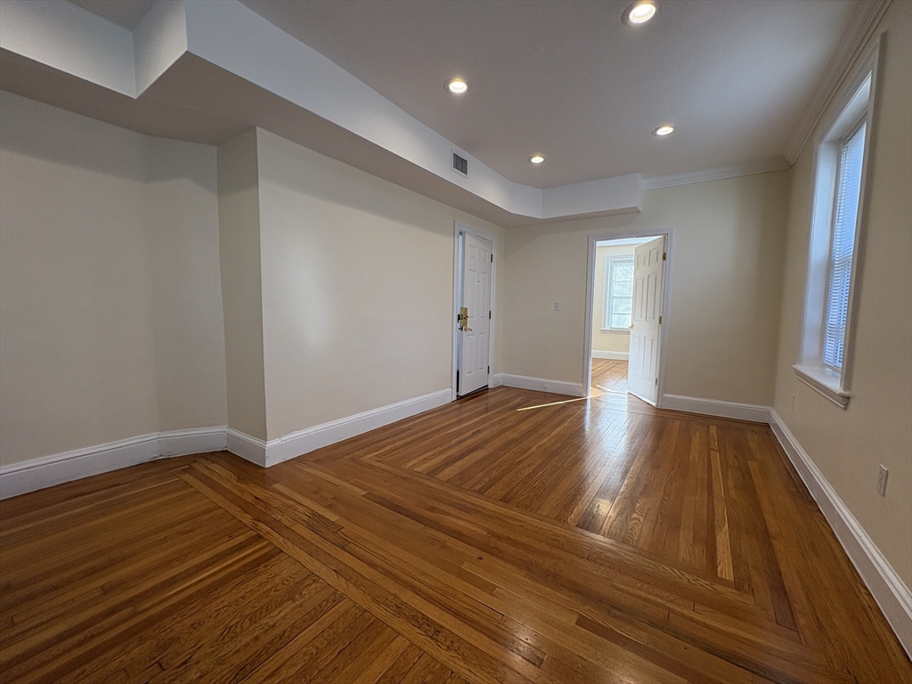 73 Thatcher Street, Unit 301 Brookline, MA 02446 - Photo 6 of 15 a view of empty room with wooden floor