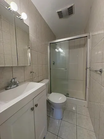 a bathroom with a sink toilet and shower