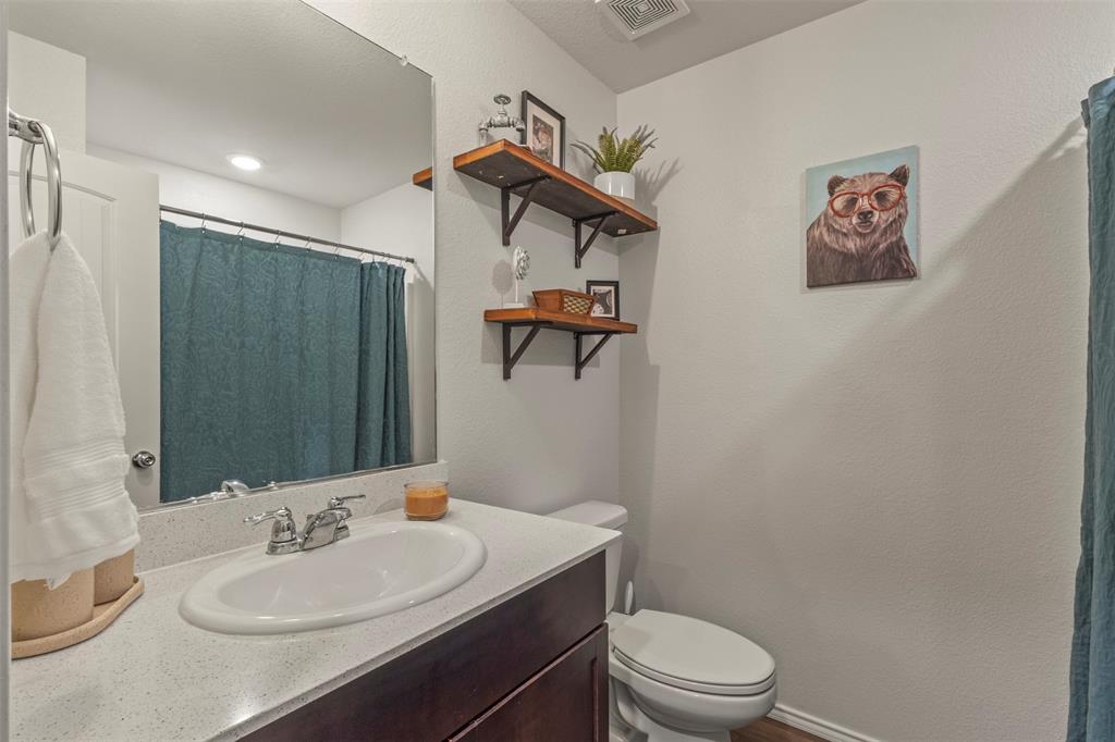 217 Anvil Drive Haslet, TX 76052 - Photo 12 of 18 a bathroom with a sink a toilet and shower