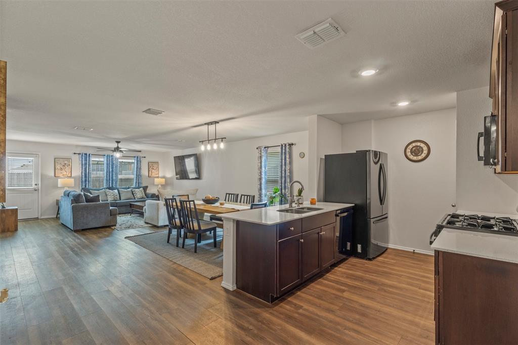 217 Anvil Drive Haslet, TX 76052 - Photo 15 of 18 a living room with furniture a wooden floor and a couch