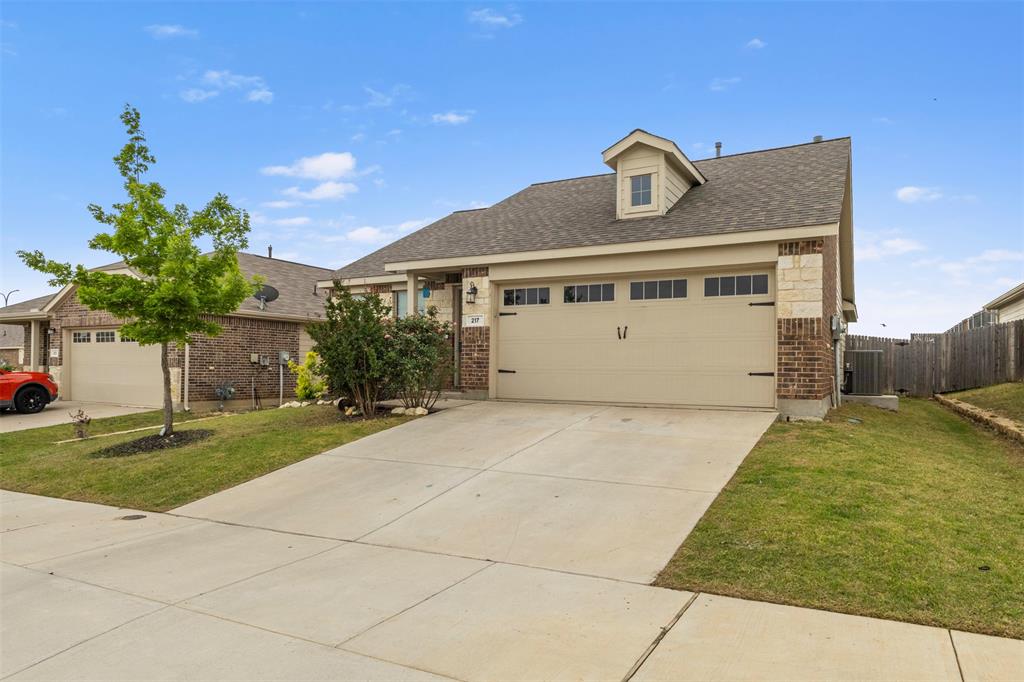 217 Anvil Drive Haslet, TX 76052 - Photo 2 of 18 a front view of a house with a yard and garage
