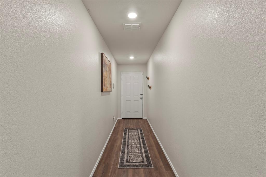 217 Anvil Drive Haslet, TX 76052 - Photo 3 of 18 a view of a hallway with wooden floor