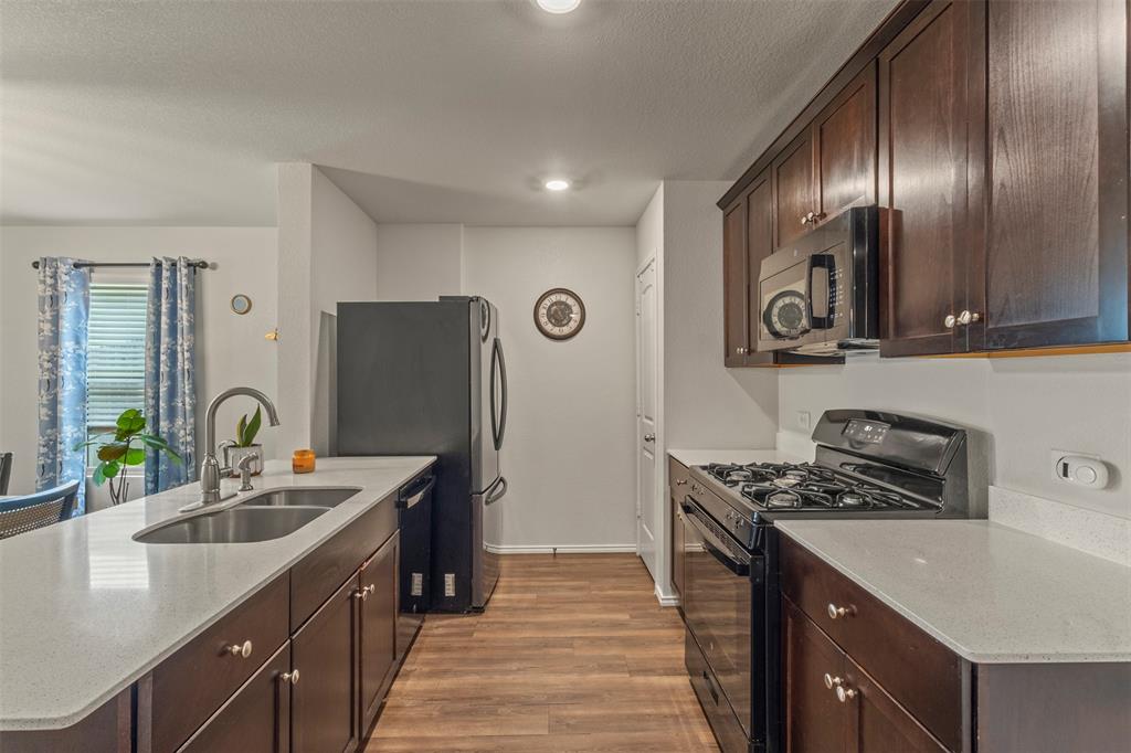 217 Anvil Drive Haslet, TX 76052 - Photo 6 of 18 a kitchen with a sink stove and refrigerator