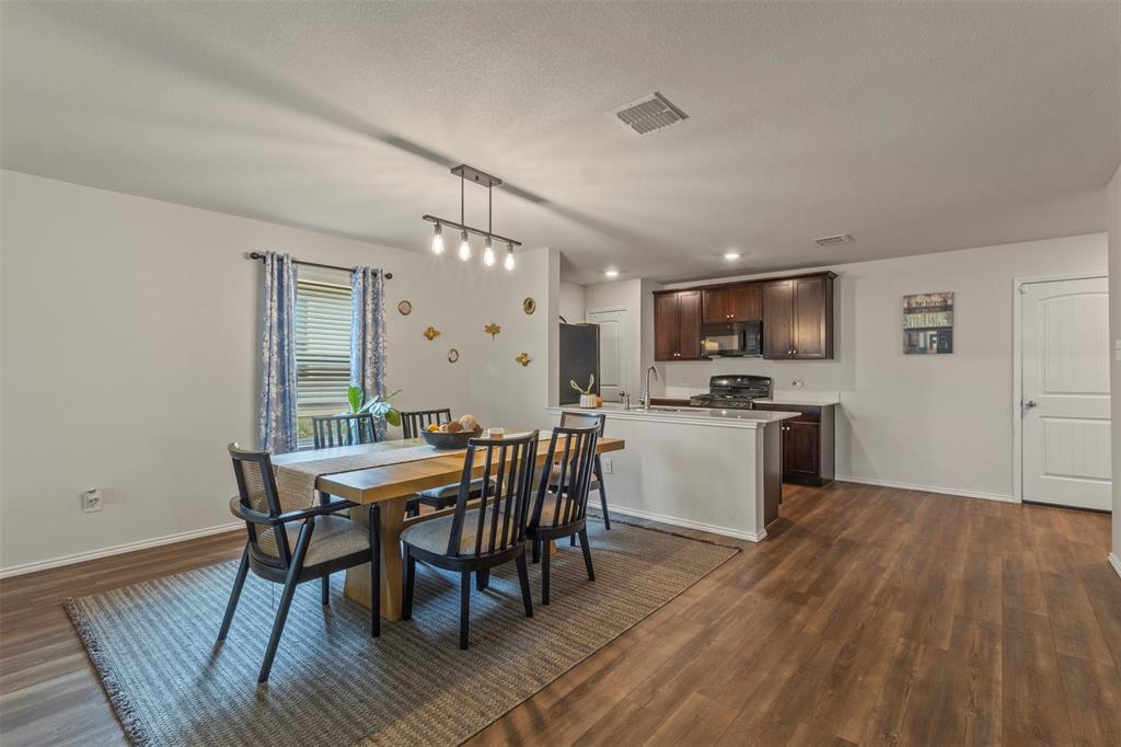 217 Anvil Drive Haslet, TX 76052 - Photo 8 of 18 a view of a dining room with furniture and wooden floor