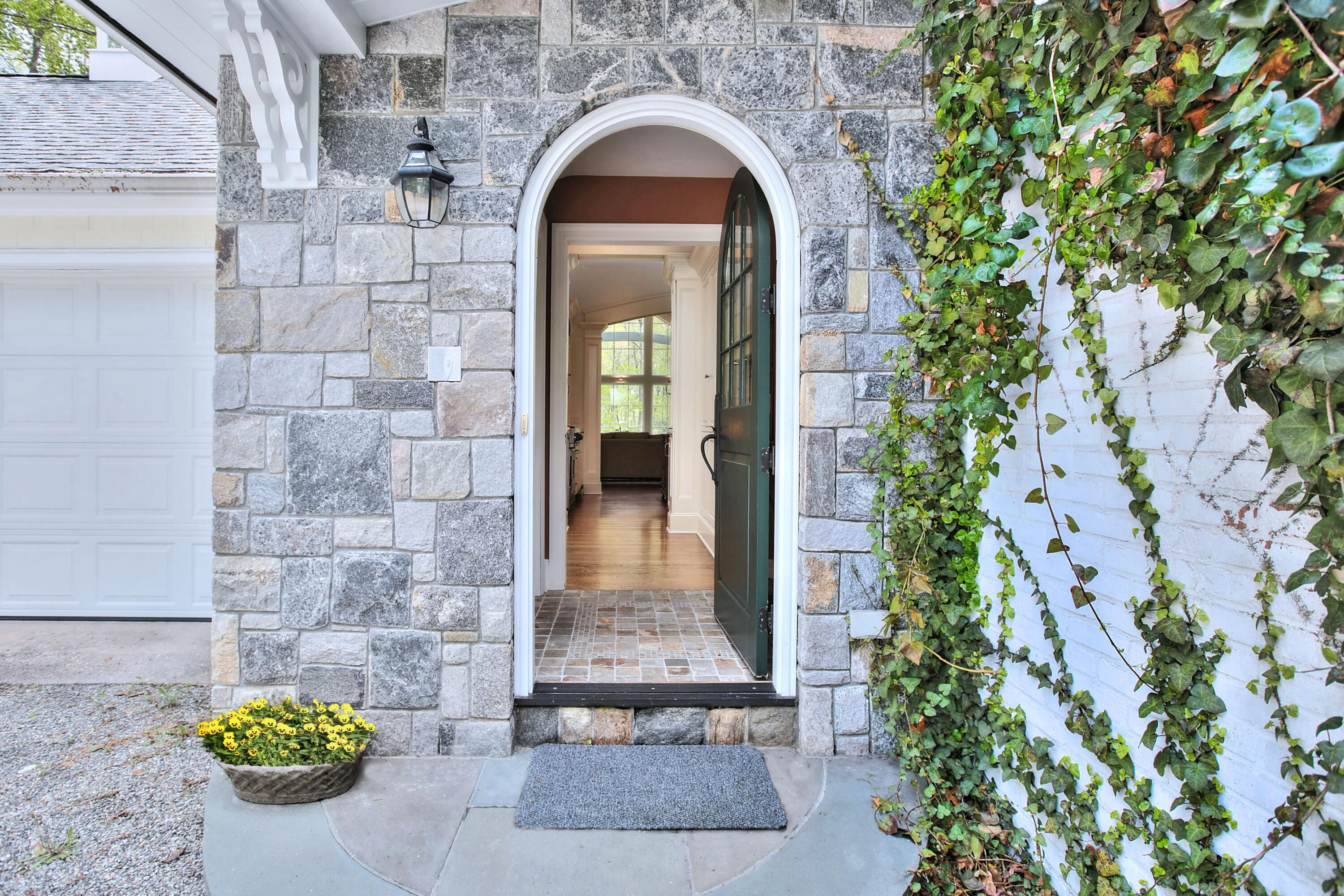 229 Smith Ridge Road New Canaan, CT 06840 - Photo 2 of 28 a view of a brick house with potted plants