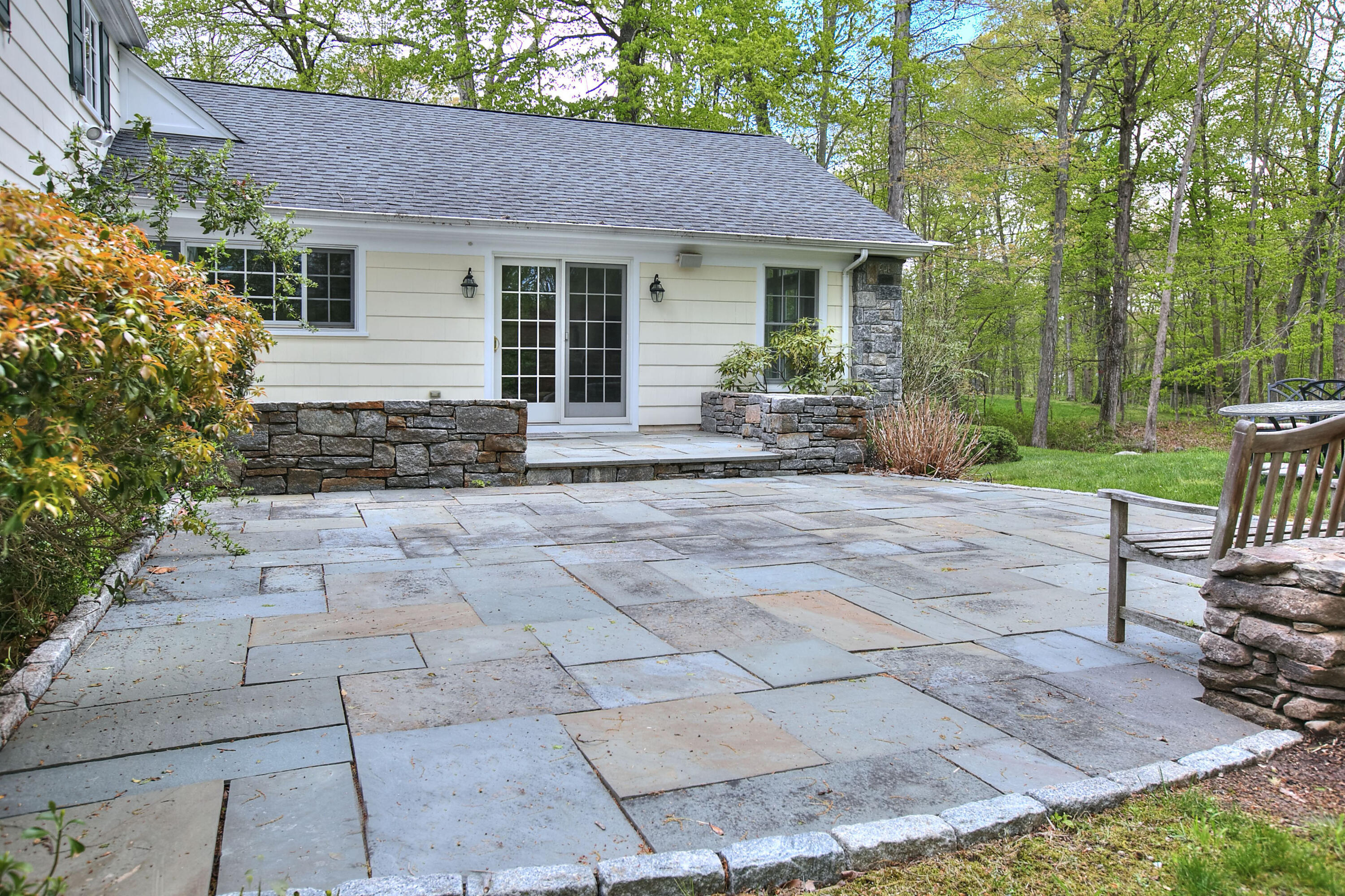 229 Smith Ridge Road New Canaan, CT 06840 - Photo 26 of 28 a backyard of a house with yard and outdoor seating