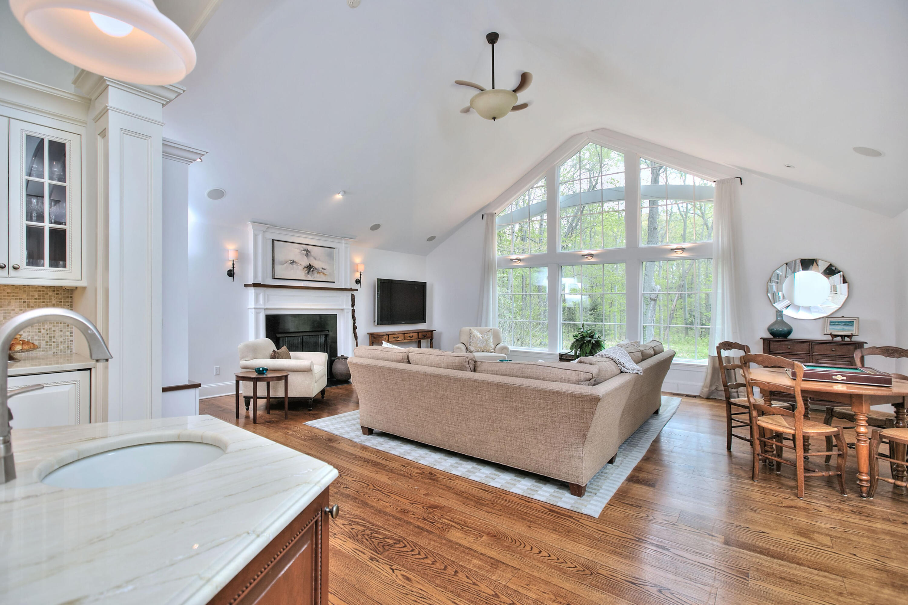 229 Smith Ridge Road New Canaan, CT 06840 - Photo 3 of 28 a living room with furniture large window and wooden floor