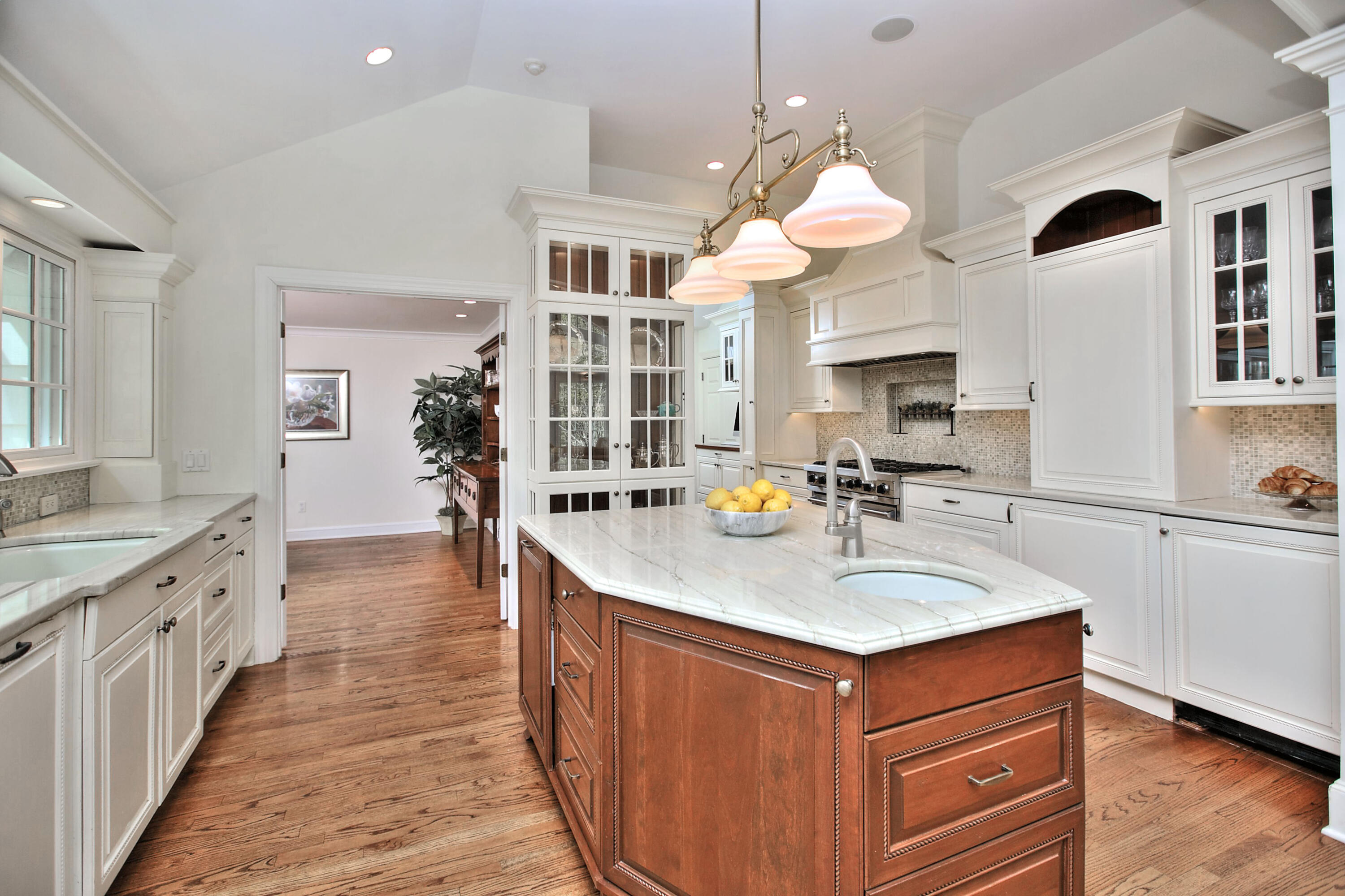 229 Smith Ridge Road New Canaan, CT 06840 - Photo 9 of 28 a kitchen with stainless steel appliances granite countertop a sink a stove and a wooden floors