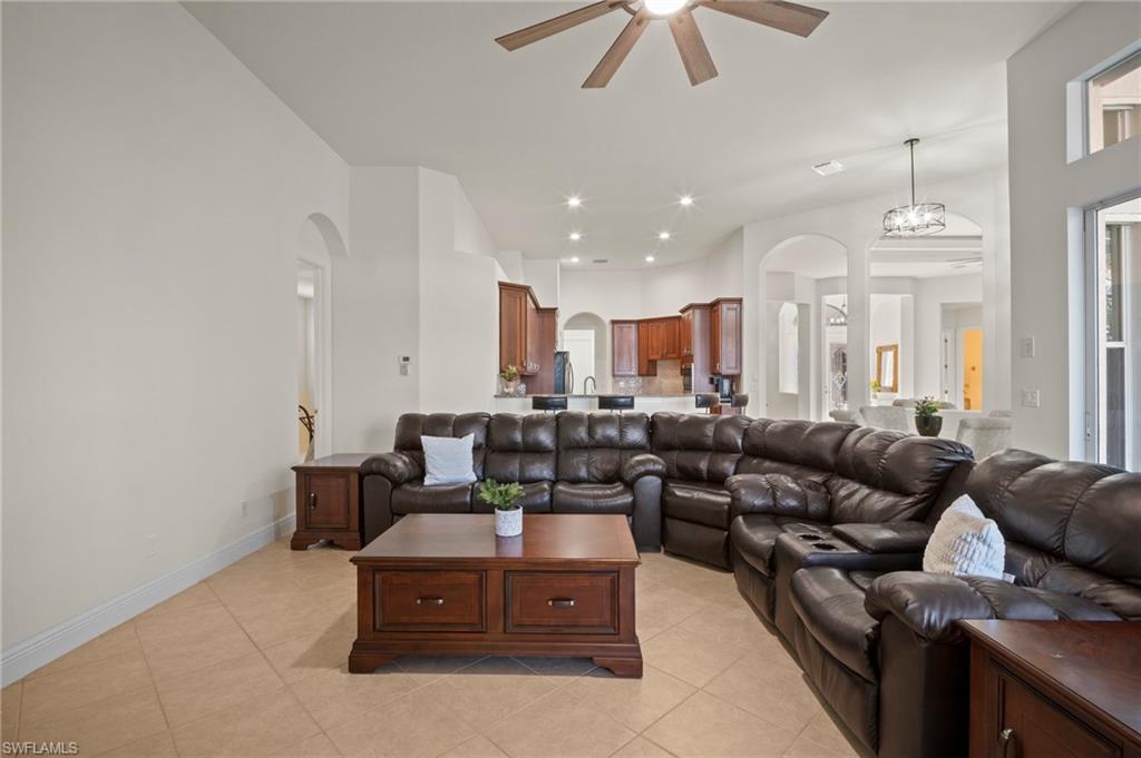 19415 La Serena Drive Estero, FL 33967 - Photo 11 of 49 a living room with furniture kitchen view and a chandelier