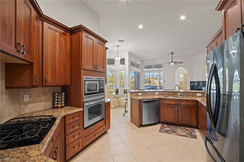 19415 La Serena Drive Estero, FL 33967 - Photo 14 of 49 a kitchen with stainless steel appliances granite countertop a stove top oven a sink and dishwasher