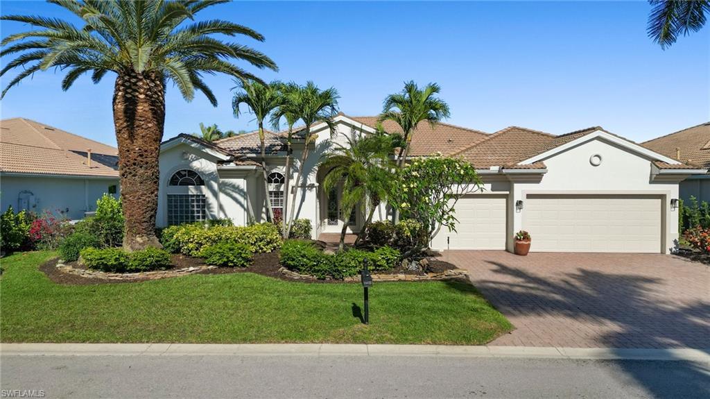 19415 La Serena Drive Estero, FL 33967 - Photo 2 of 49 a front view of a house with a yard and garage