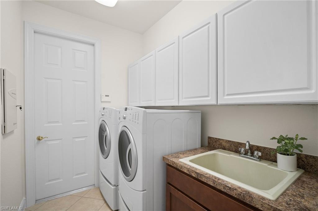 19415 La Serena Drive Estero, FL 33967 - Photo 29 of 49 a bathroom with a sink and washing machine