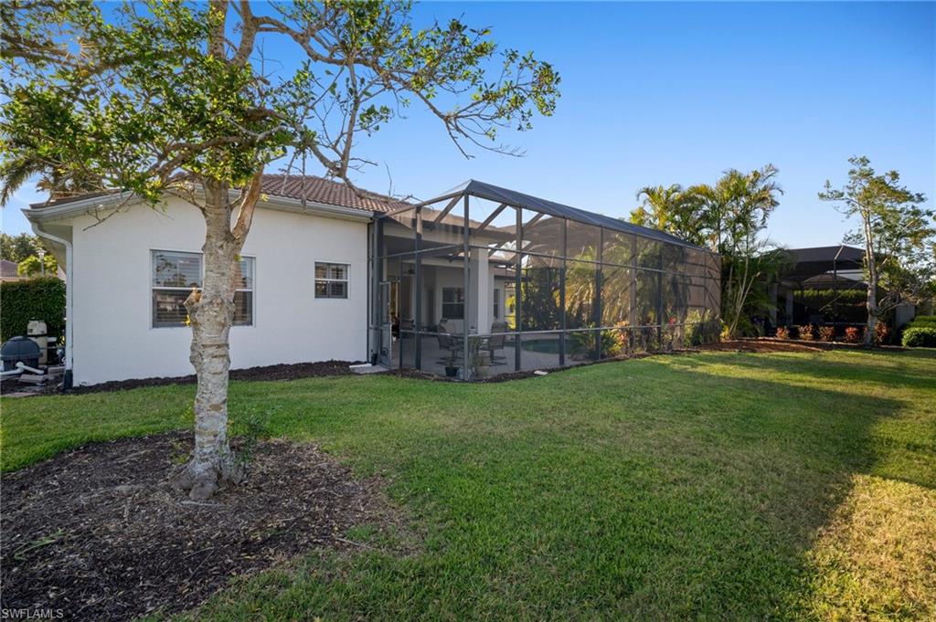 19415 La Serena Drive Estero, FL 33967 - Photo 36 of 49 a view of a house with backyard and a tree