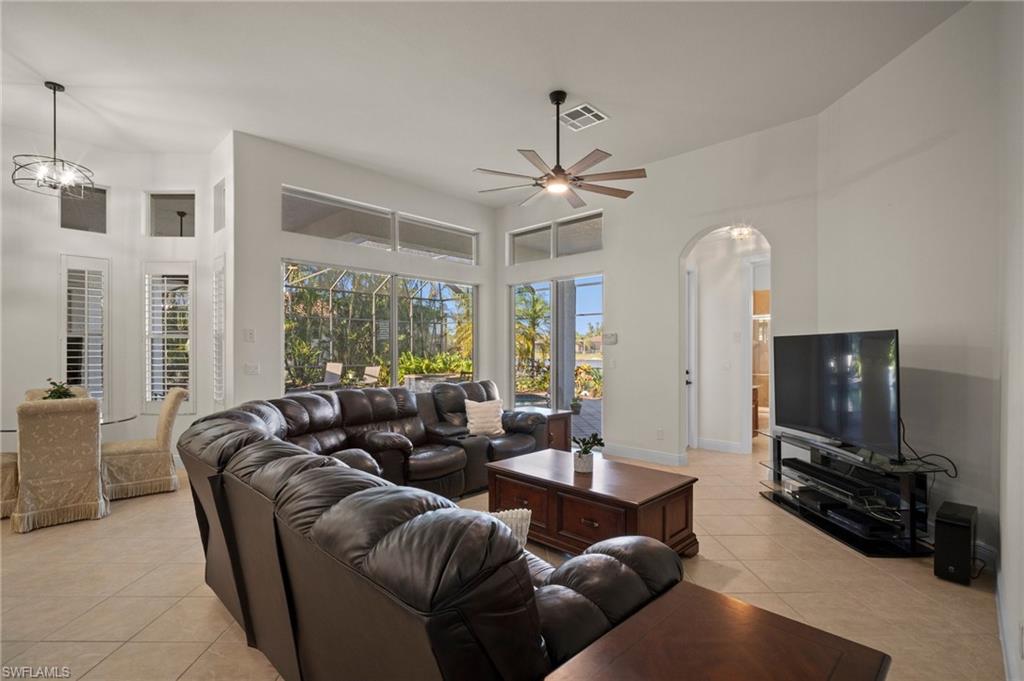 19415 La Serena Drive Estero, FL 33967 - Photo 10 of 49 a living room with furniture a ceiling fan and a flat screen tv