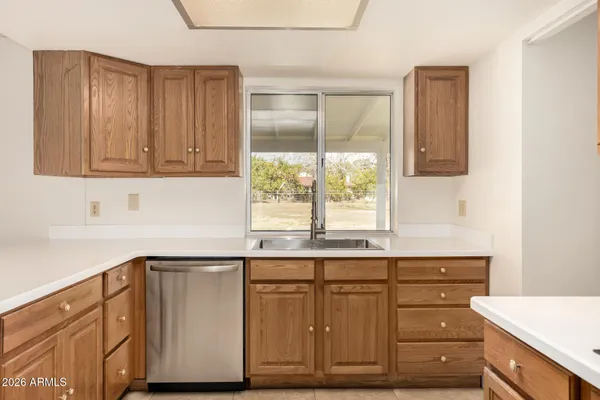 a kitchen with kitchen island a sink stainless steel appliances and cabinets