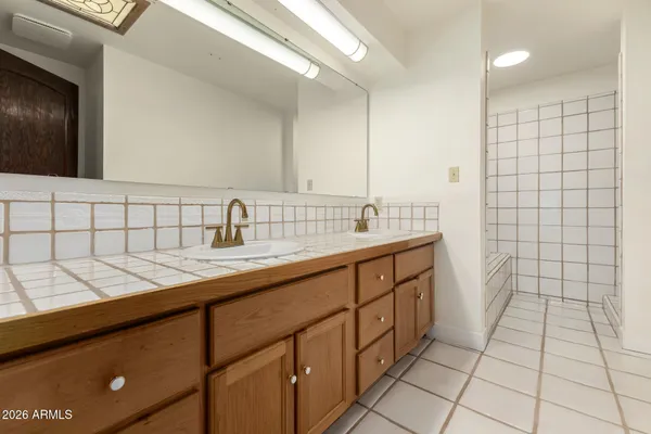 a white toilet next to a shower
