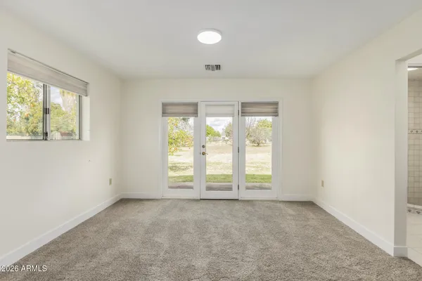 a room with furniture a baby crib and a window