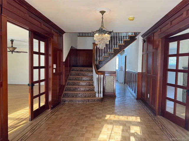 a view of entryway and hall with wooden floor