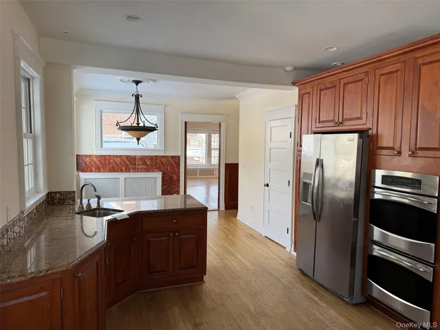 a kitchen with stainless steel appliances granite countertop a refrigerator and a sink